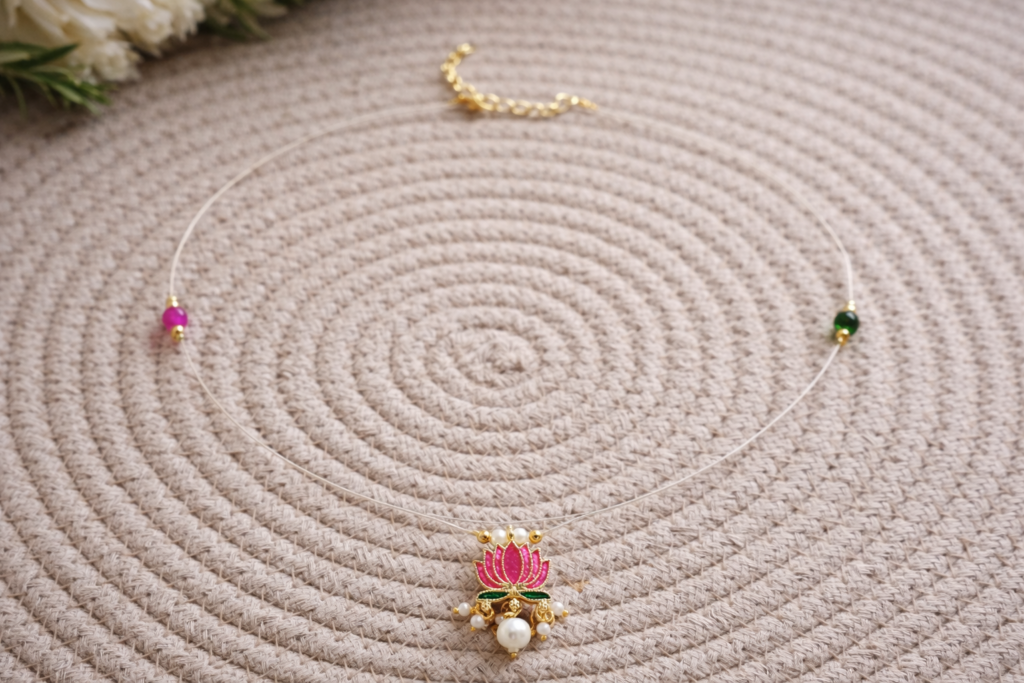 “Delicate invisible necklace with pink lotus pendant and pearl drop”