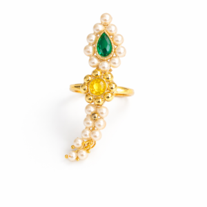 Pearl Nath finger ring with green teardrop stone and yellow round stone on a cream background