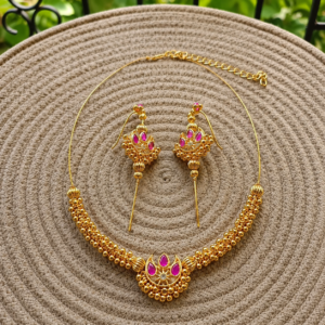 Chandra Invisible Choker & Ear Cuffs in pink displayed on a woven mat with a blurred garden background.