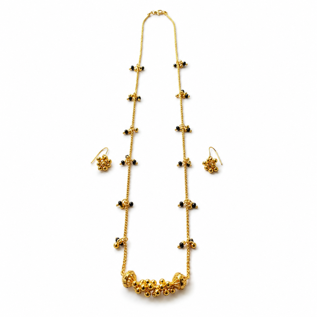 Golden Mangalsutra with matching earrings displayed on a white background.