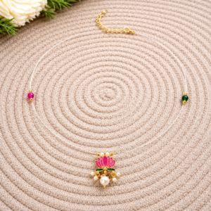 Lotus Invisible Necklace displayed on a woven mat with a floral background.