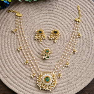 Mor Pankh Necklace Set with matching earrings and ring displayed on a woven mat.