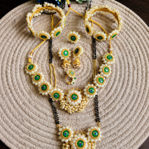 Mor Pankh Saaj Set with matching necklace, bangles, earrings, ring, and pendant arranged on a woven mat.